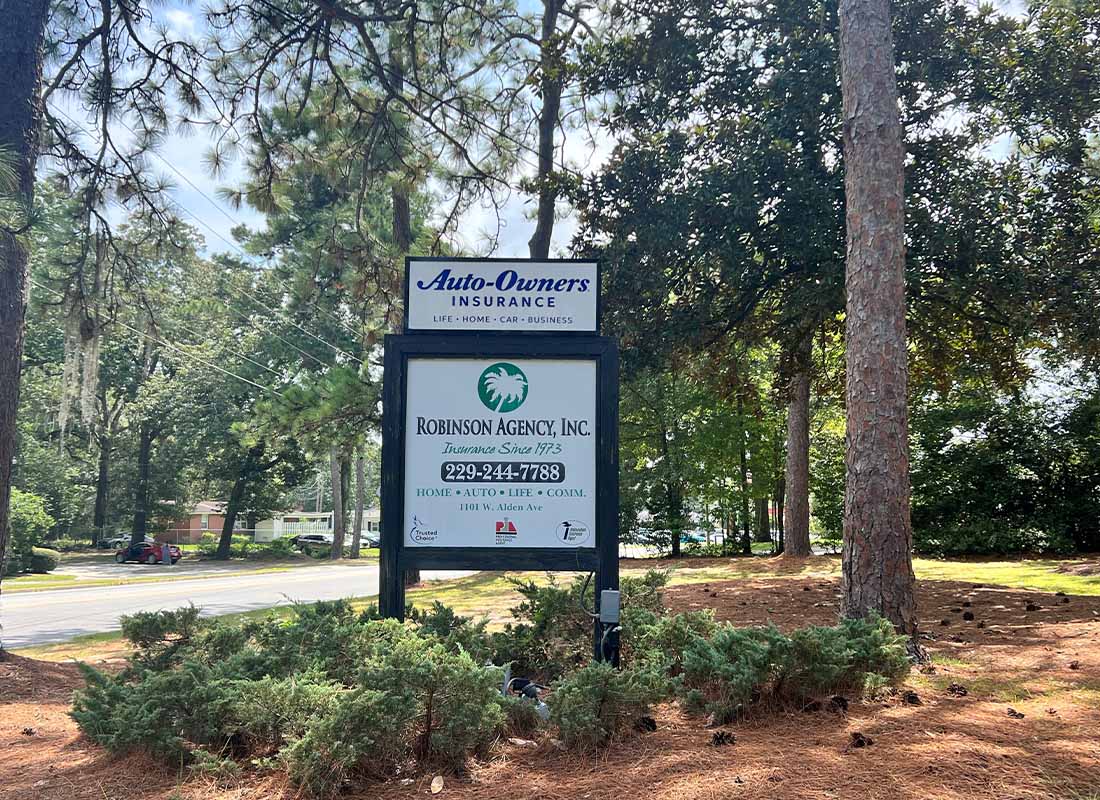 Contact - Robinson Agency Sign by the Road Surrounded by Trees